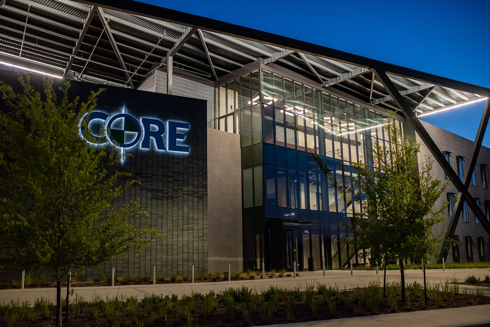 Front of the CORE Construction headquarters building at night.