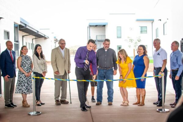 A group of people gathered at Desert Sunset Elementary School in Buckeye to cut the ribbon for the district’s newest facility.